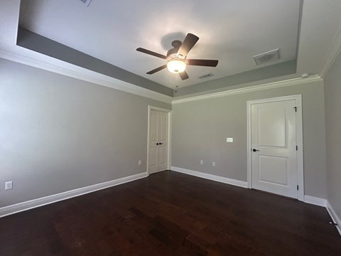 a empty living room with a ceiling fan