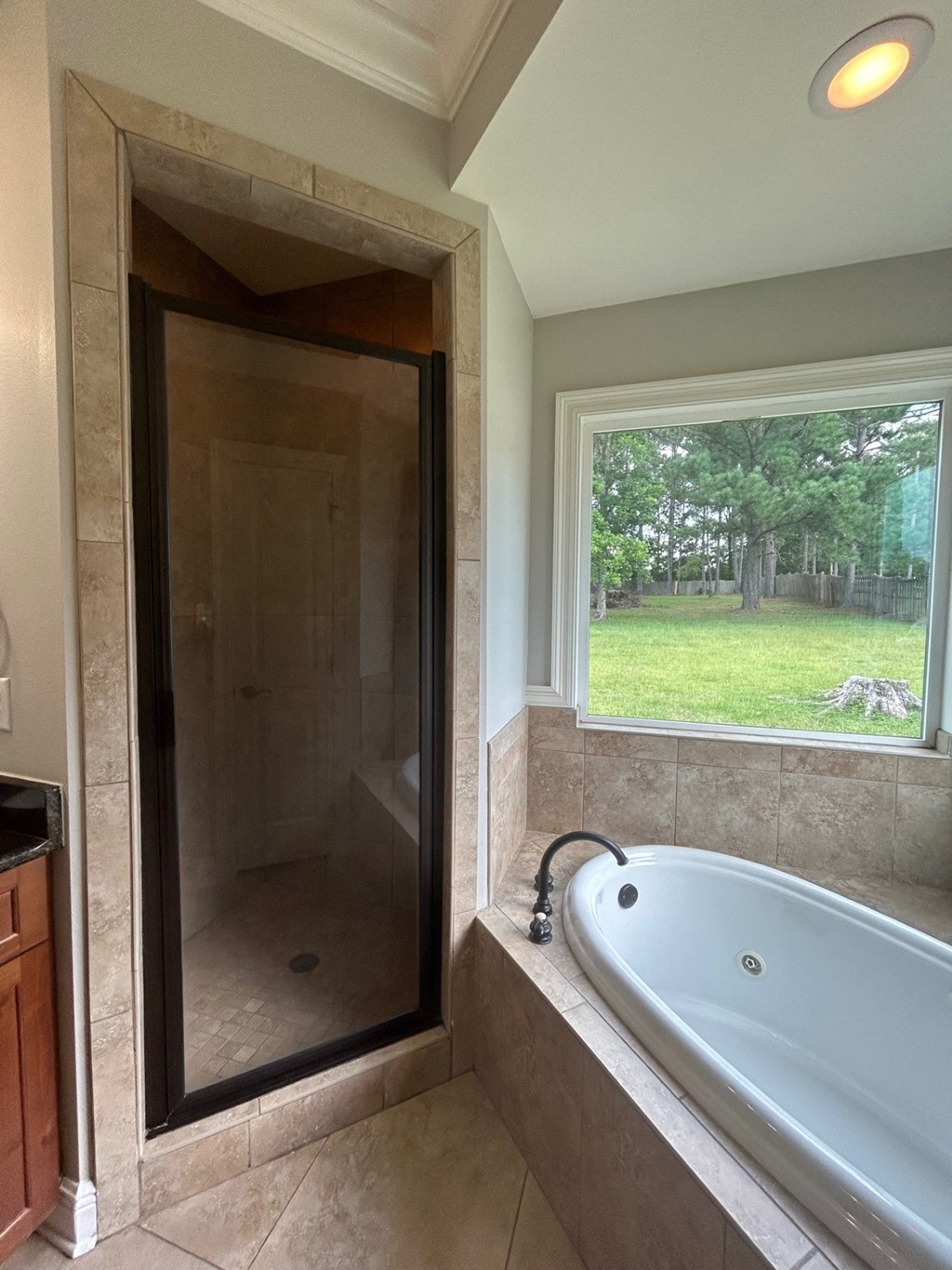 the master bathroom has a large tub and a walk in shower