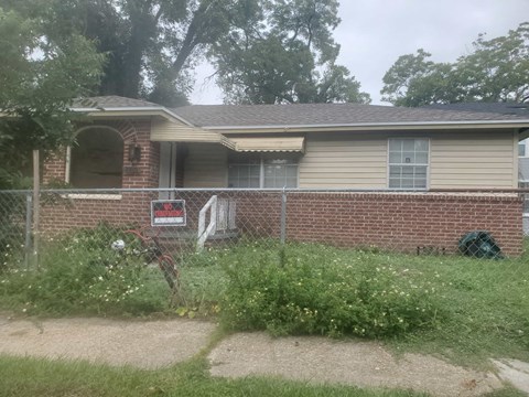 a house with a fence in front of it
