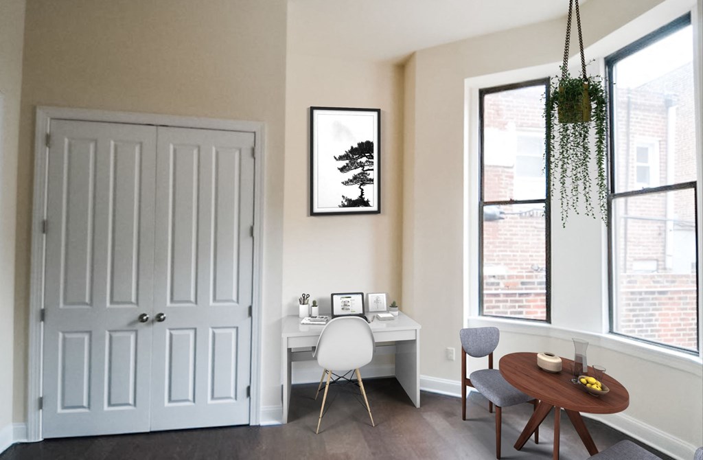 a home office with a desk and chair and a window