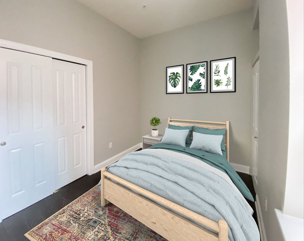 a bedroom with a bed and some pictures on the wall