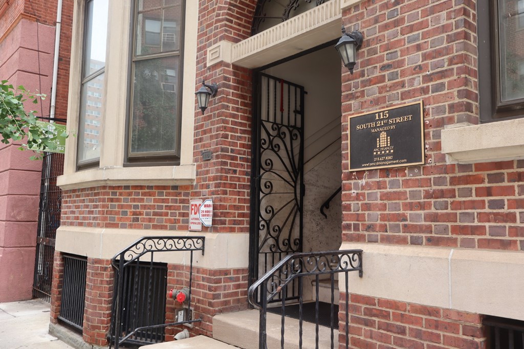 A brick building with a sign that says 115 South Street.