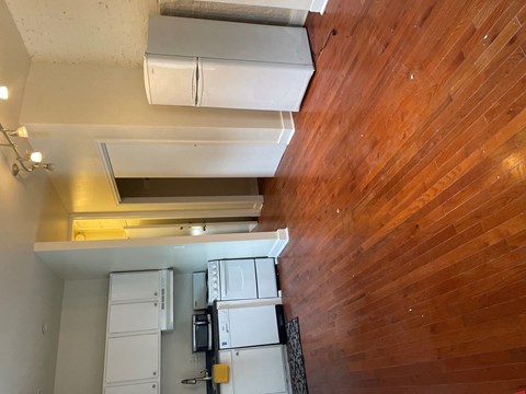 an overhead view of a kitchen with a wood floor and