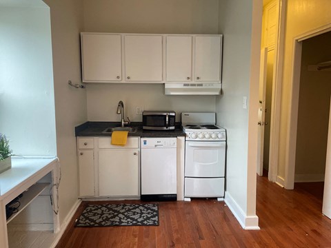 a kitchen with white appliances and white cabinets