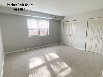an empty room with two closets and a window