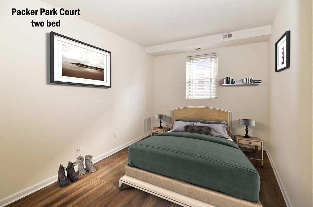 a bedroom with a bed and a framed picture on the wall