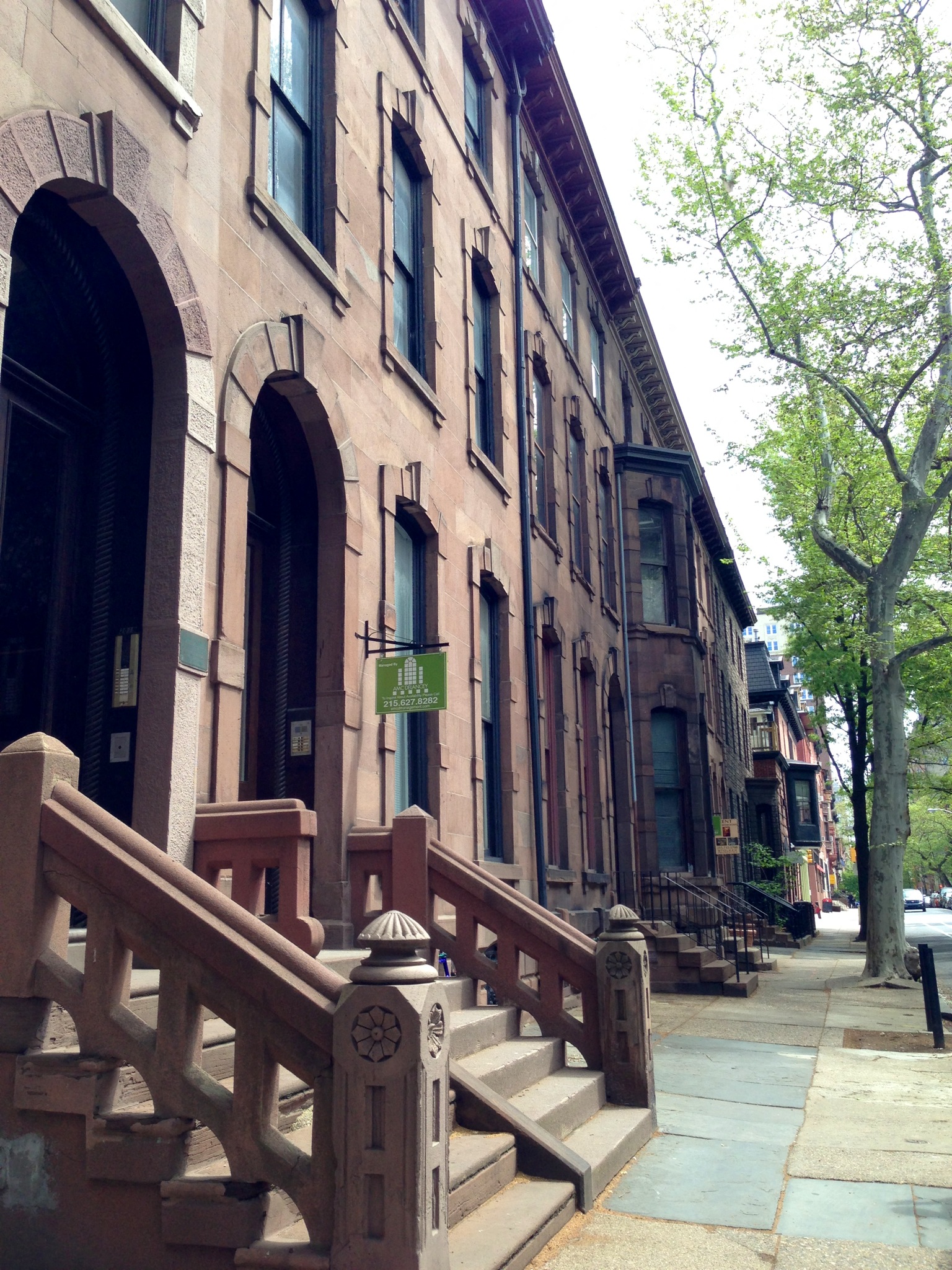 a row of buildings on a city street with stairs