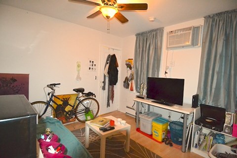 a living room with a tv and a bike in it