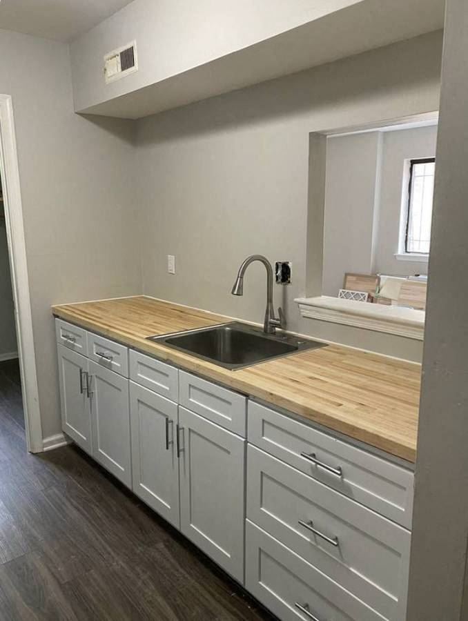 a kitchen with a sink and wooden counter tops