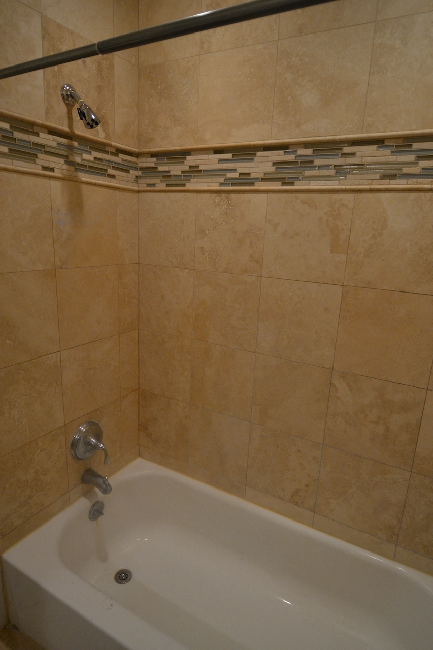 a bathroom with a shower and a bath tub
