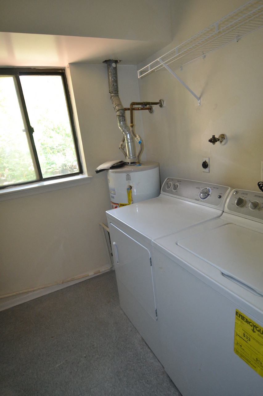 the laundry room has a washer and dryer and a window