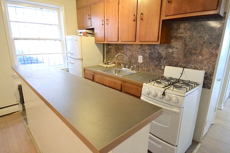 a kitchen with a counter and a stove and a sink