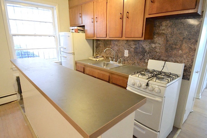 a kitchen with a counter and a stove and a sink