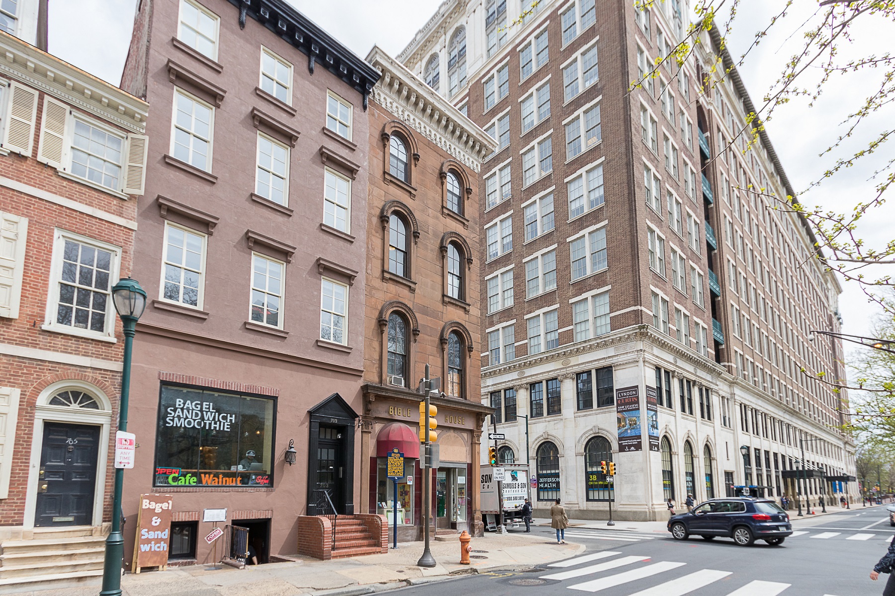 a city street with tall buildings and a crosswalk