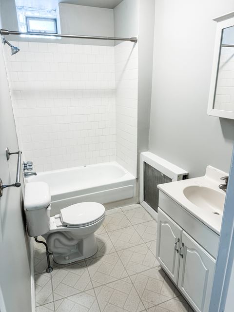 a small bathroom with a toilet and a tub and a sink