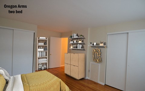 a bedroom with a bed and a dresser and a closet