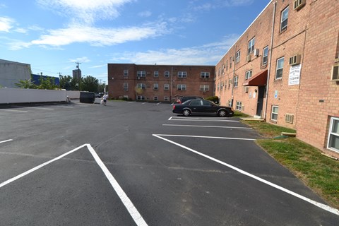 a car parked in a parking lot in front of a brick building