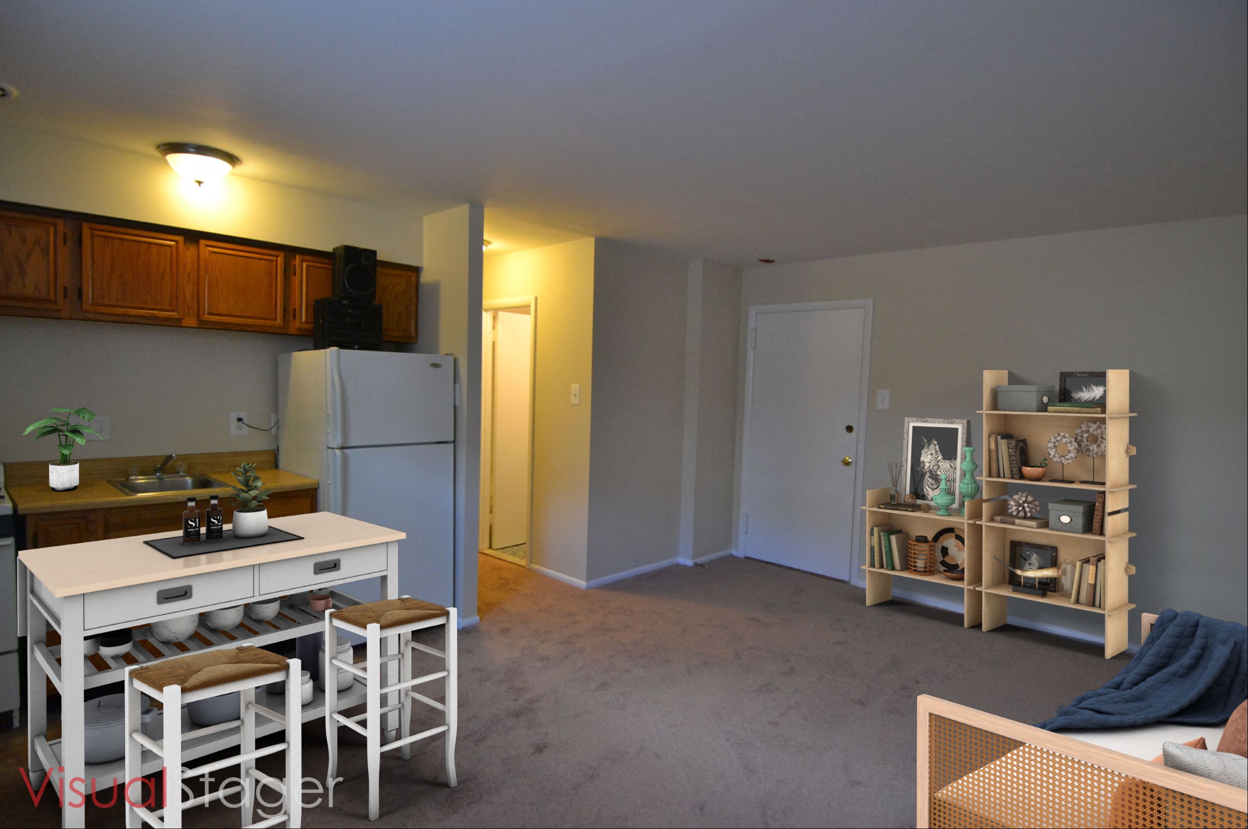 an empty living room with a kitchen and a refrigerator
