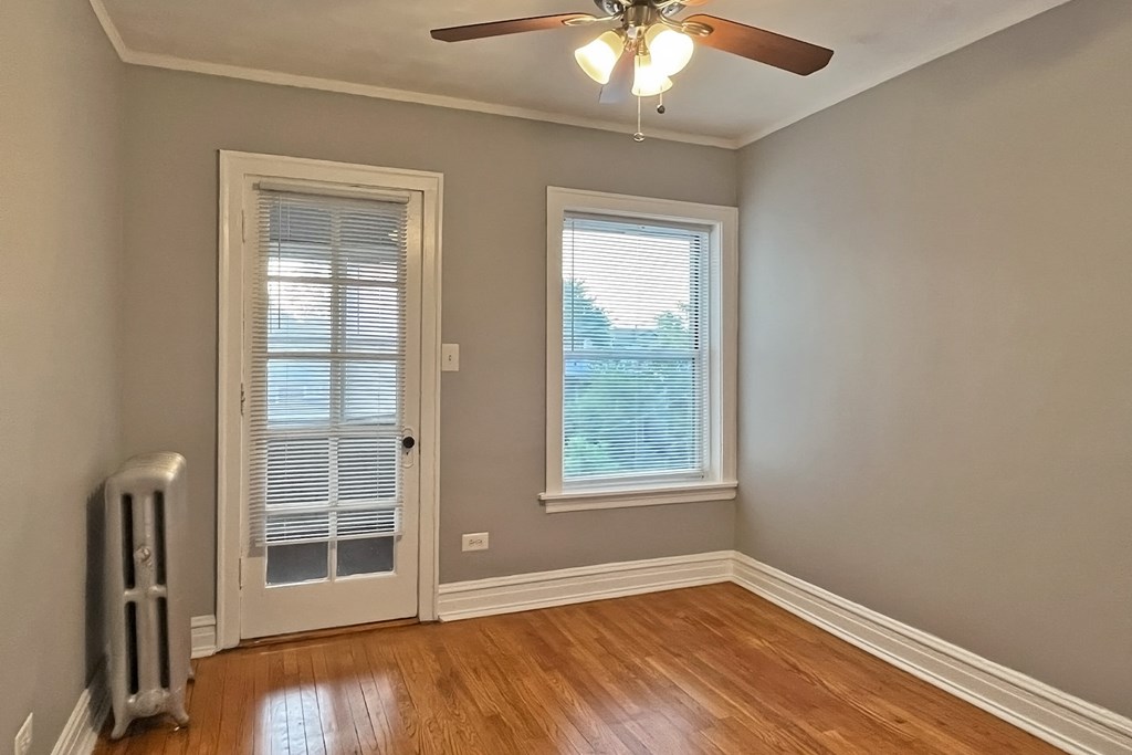A room with a window and a fan.