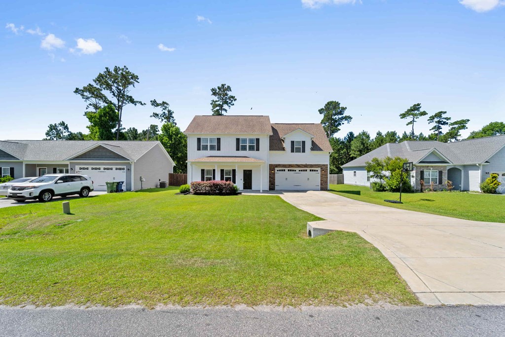 a large house with a driveway and a lawn