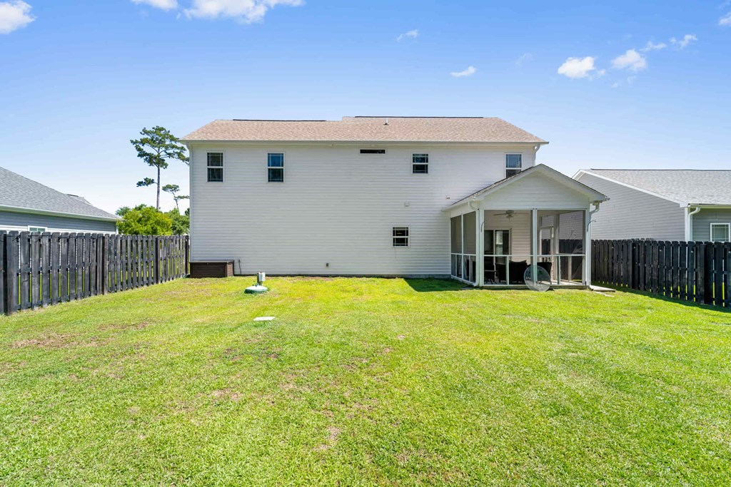 a white house with a yard in front of it