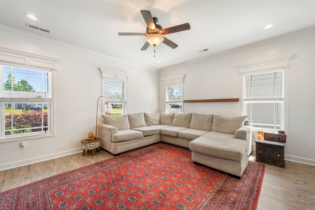 a living room with a couch and a ceiling fan