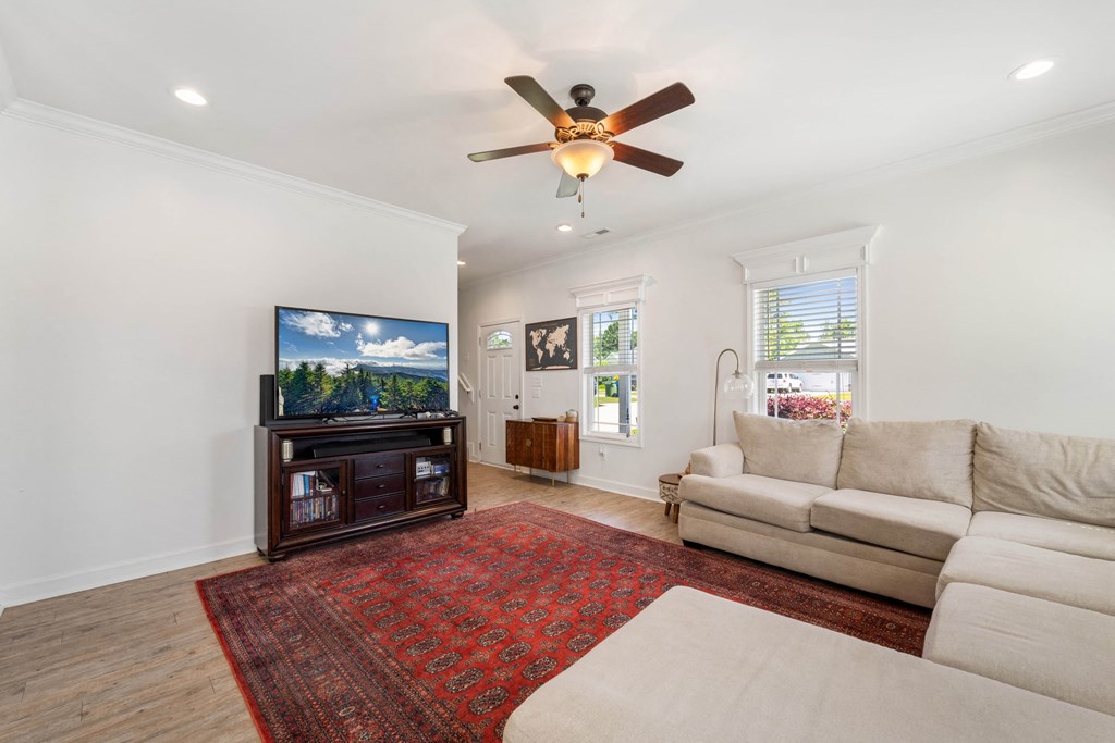 a living room with a ceiling fan and a couch