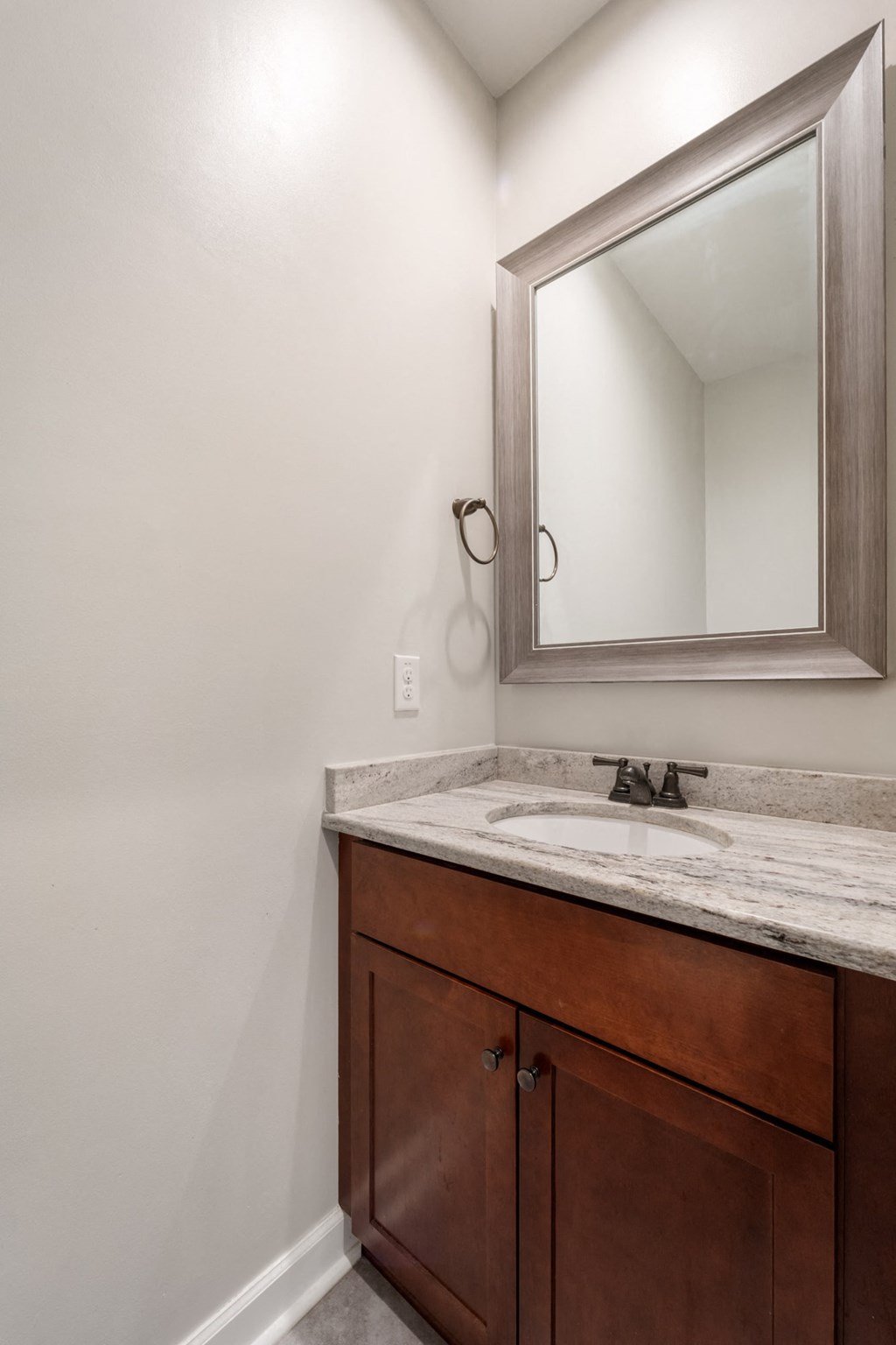 an empty bathroom with a sink and a mirror