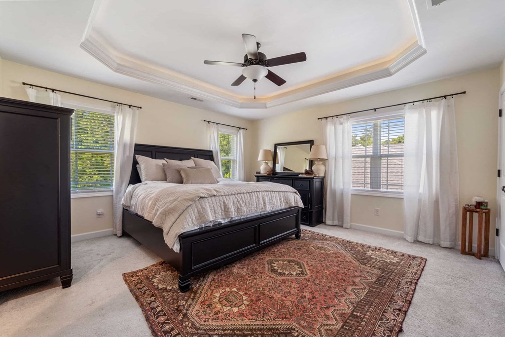a bedroom with a bed and a ceiling fan
