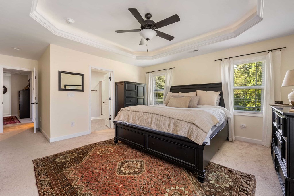 a bedroom with a bed and a ceiling fan