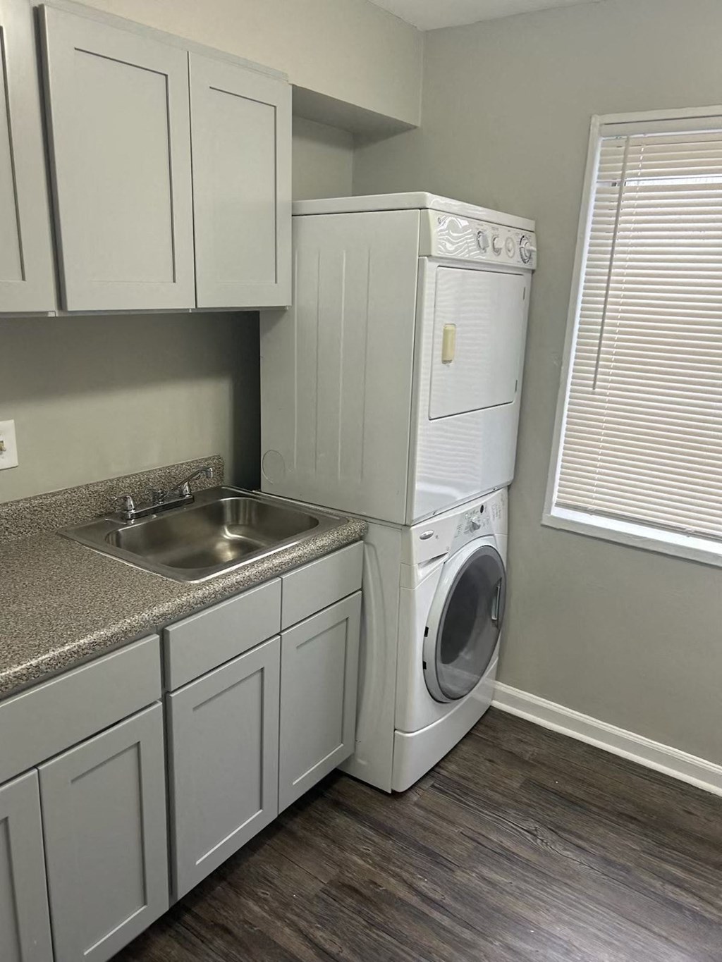 A white washing machine and dryer in a laundry room.