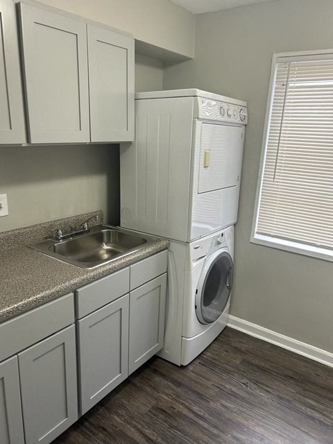 A white washing machine and dryer in a laundry room.