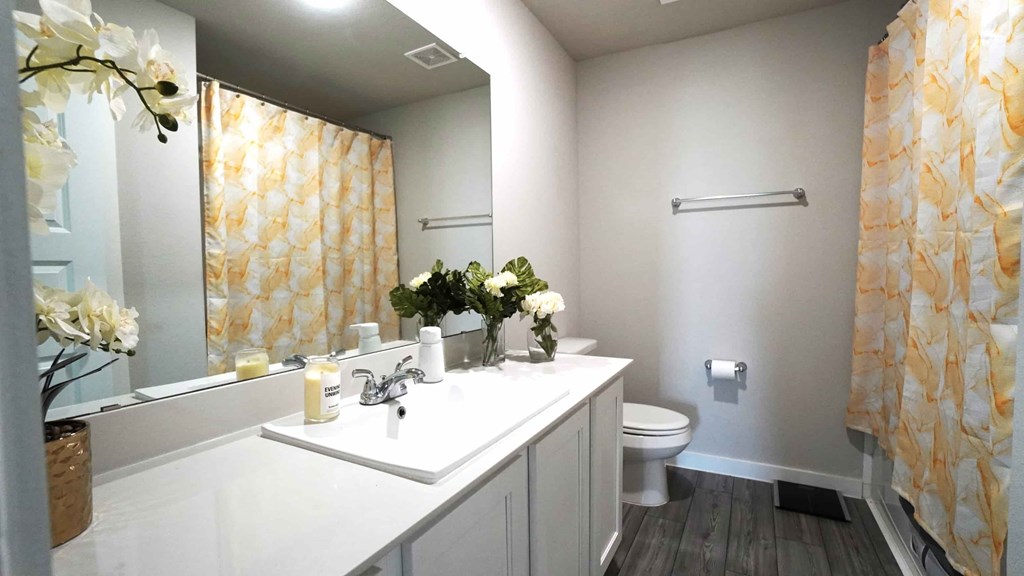 a white bathroom with a sink and a toilet