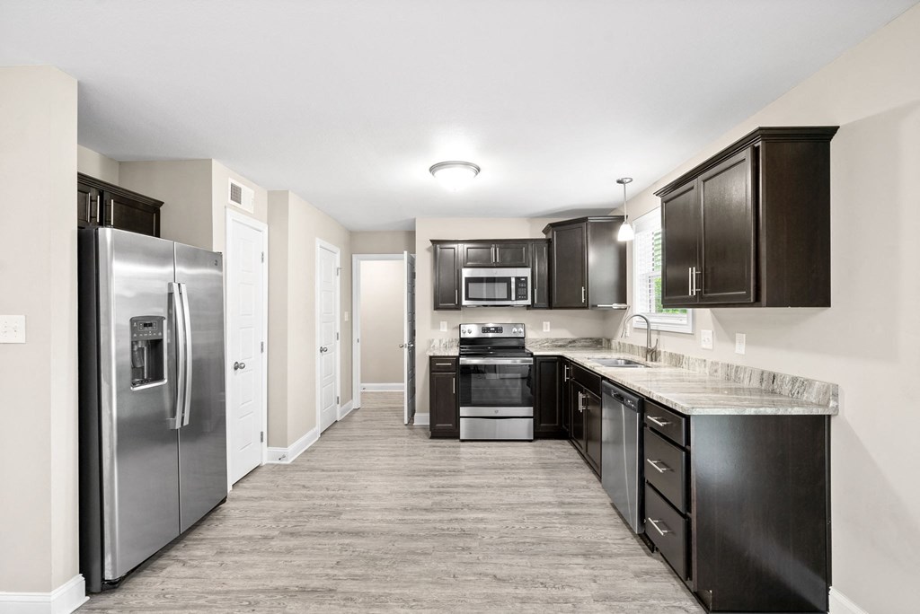 a kitchen with stainless steel appliances and black cabinets