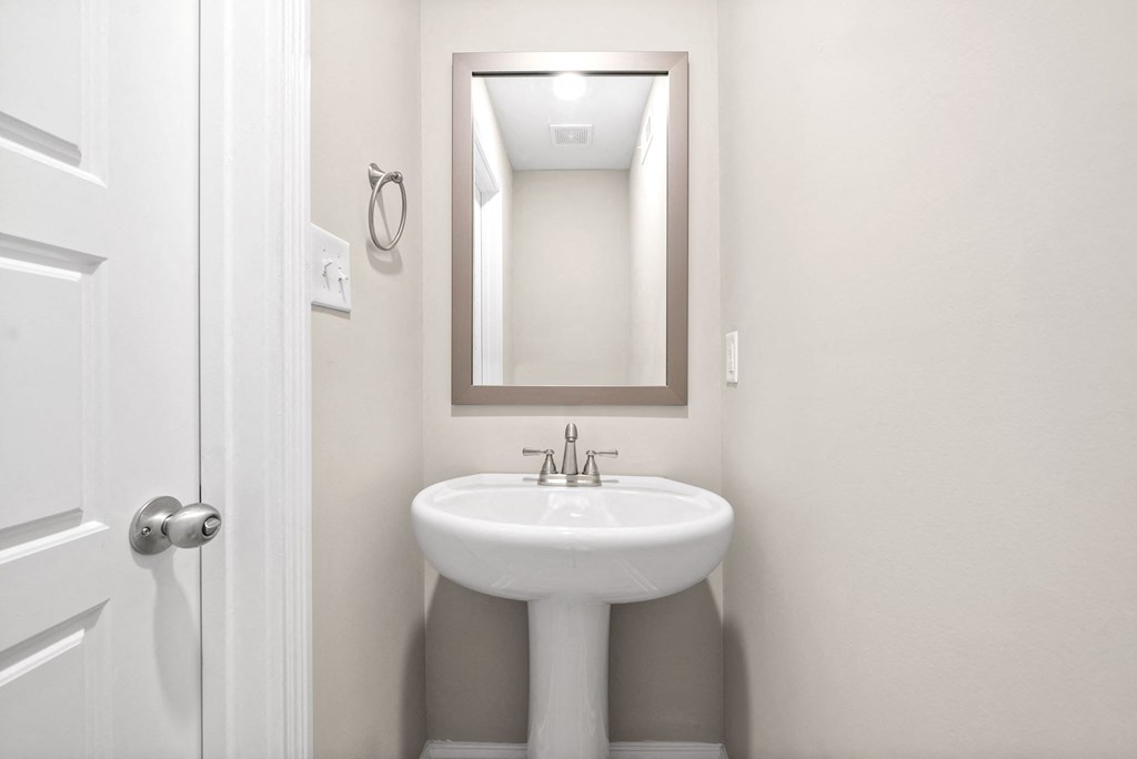 a small bathroom with a sink and a mirror