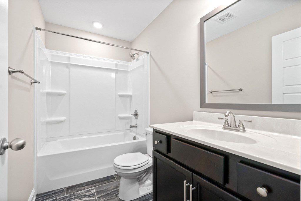 a bathroom with a sink toilet and a shower