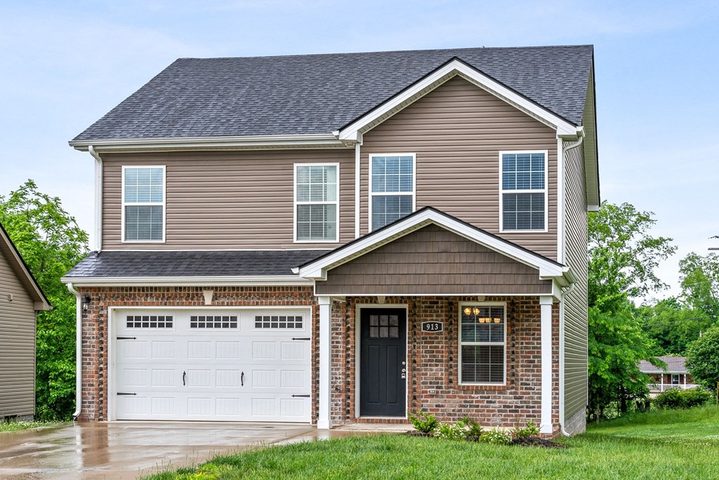 a brown house with a white garage door