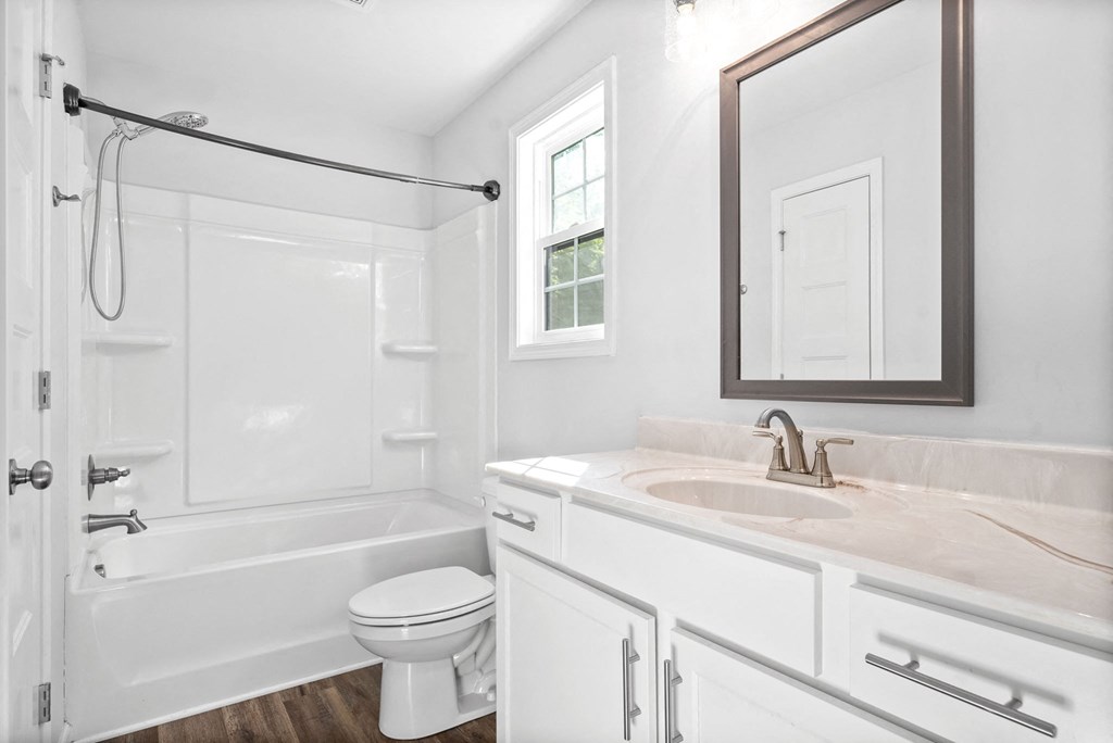 a bathroom with a sink toilet and a shower