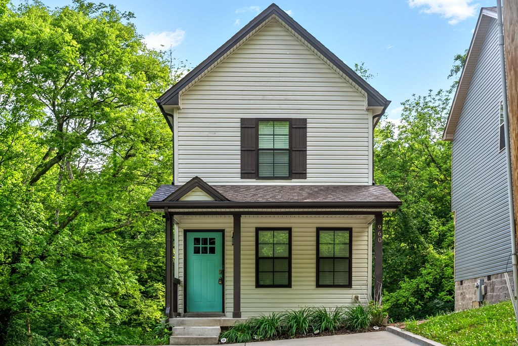 the front of a house with a green door