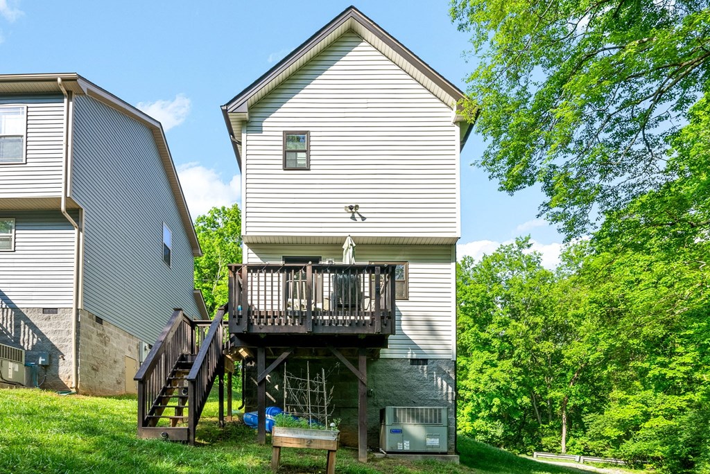 the back of a house with a deck and a staircase