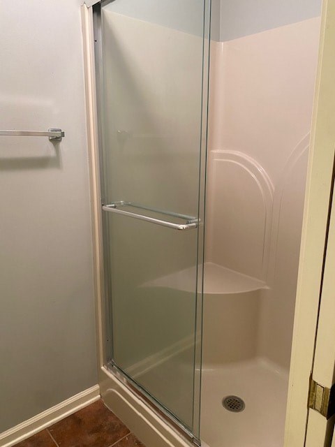 a bathroom with a shower with a glass door