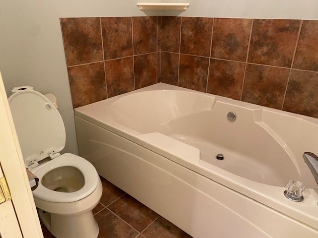 a bathroom with a bath tub and a toilet
