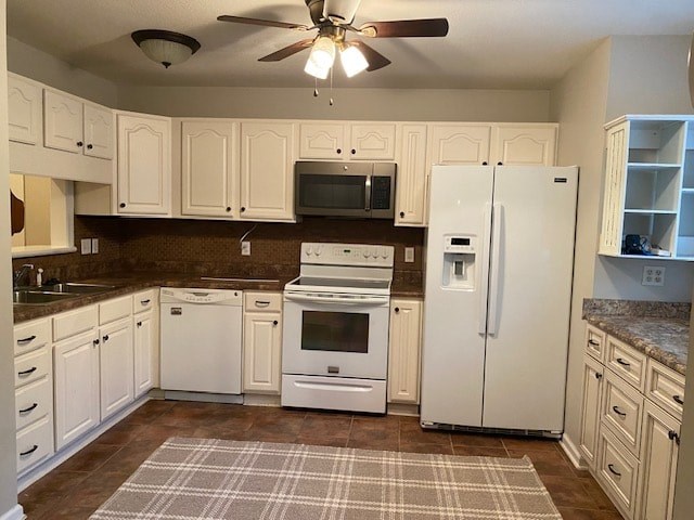 a kitchen with white cabinets and a white refrigerator