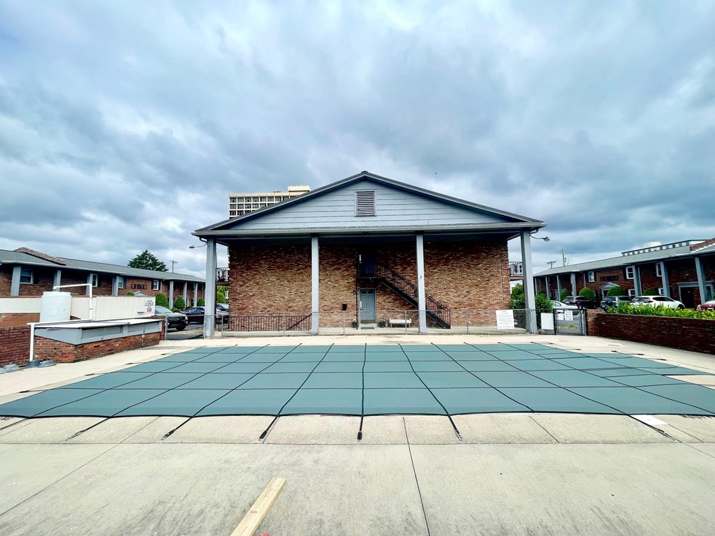 the front of a brick building with a blue tiled floor