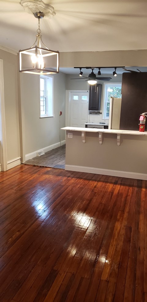 A room with a wooden floor and a ceiling fan.