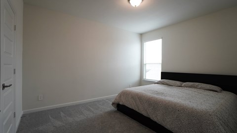 a bedroom with a bed and a window