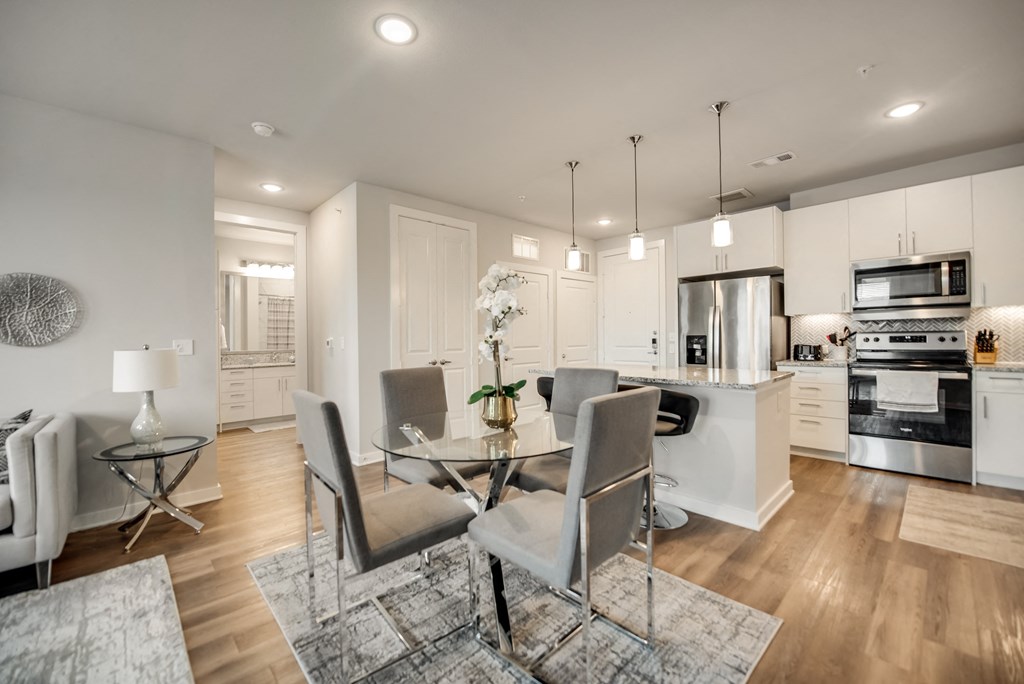 an open kitchen and dining room with a table and chairs