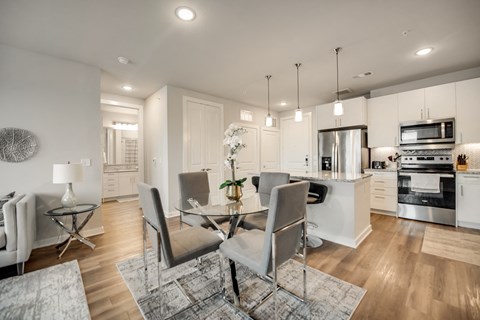 an open kitchen and dining room with a table and chairs
