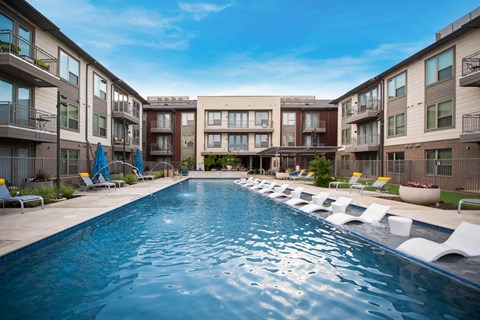 a swimming pool in front of an apartment building