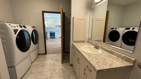 a laundry room with a sink and washing machines